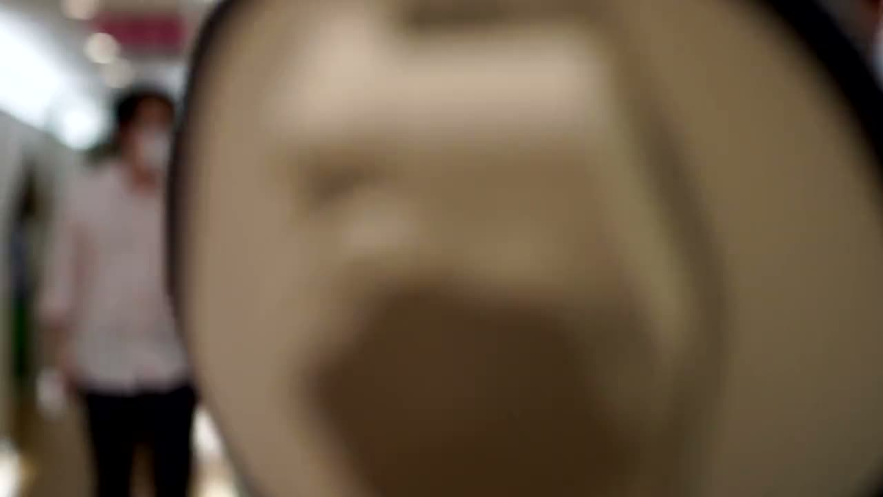 A clinician running an intraoral scanner, the patient's teeth appearing in 3D on the screen.