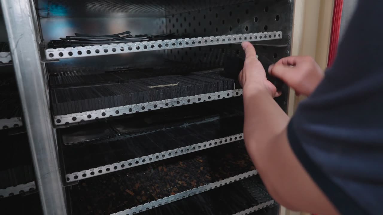 Cut acetate blanks are loaded into a slotted metal rack.