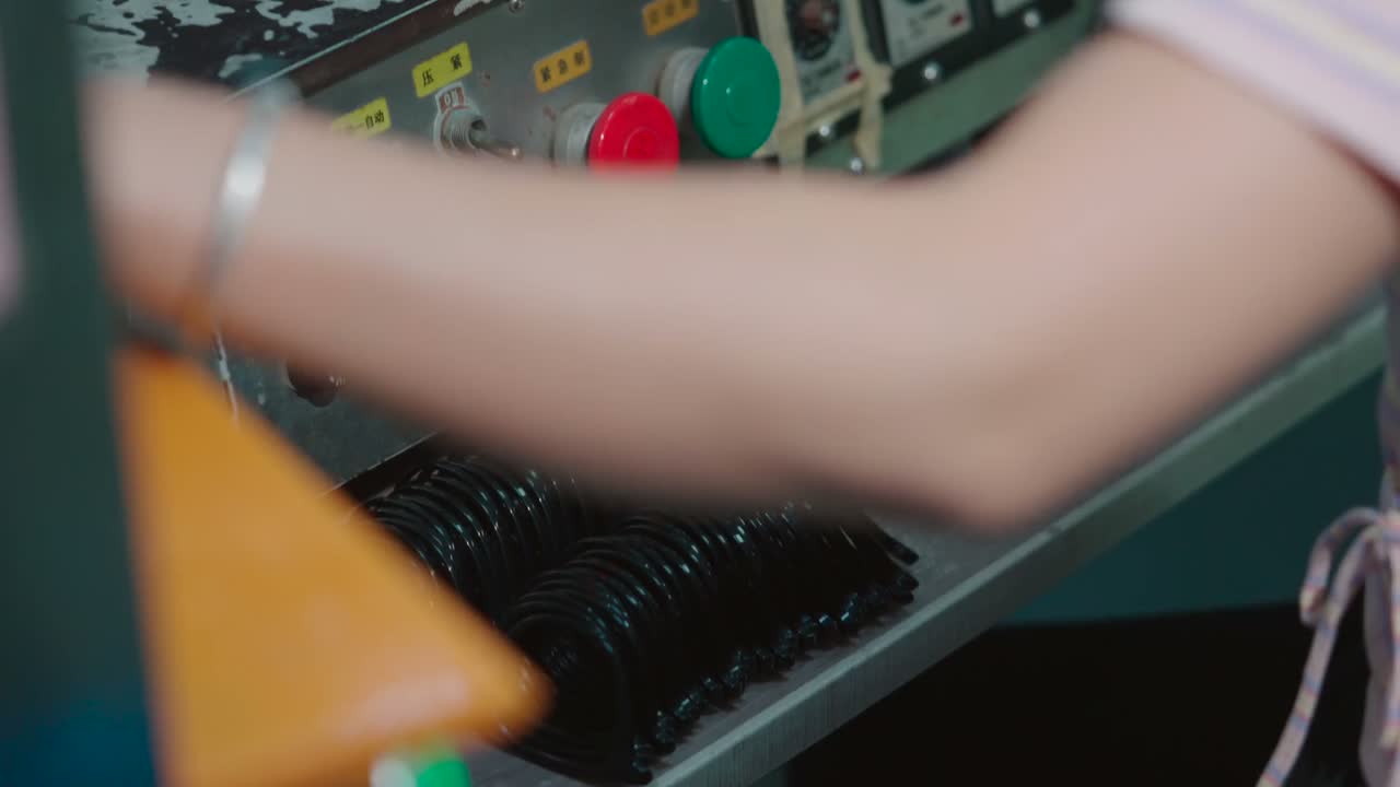 Gloved hands operate a bending press on a frame front.