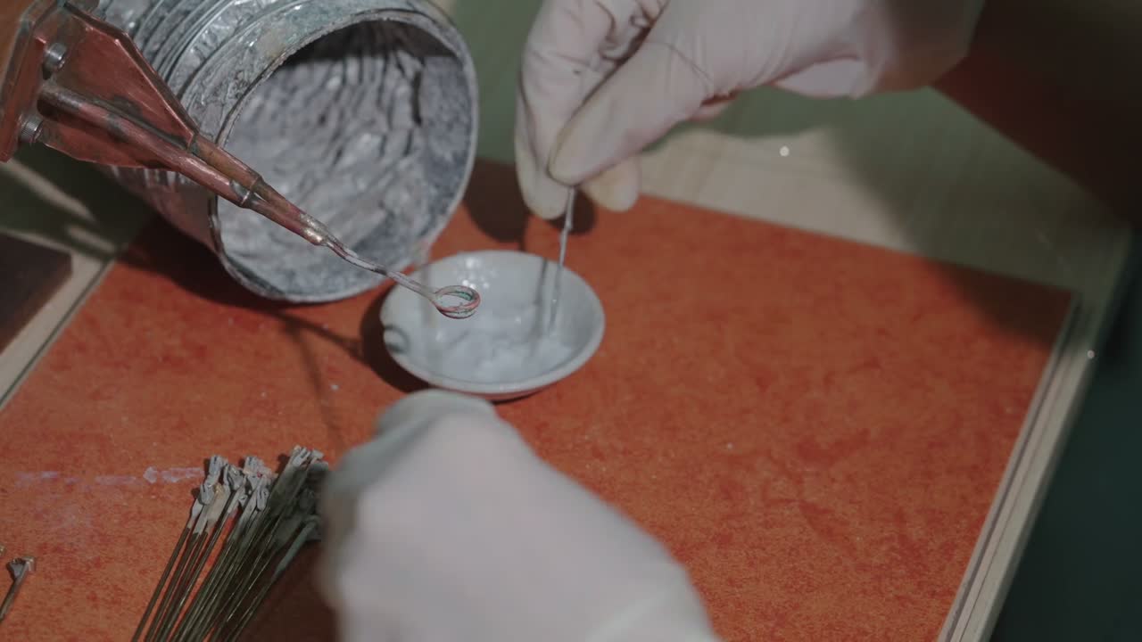 A torch is used to weld a hinge onto a metal core.