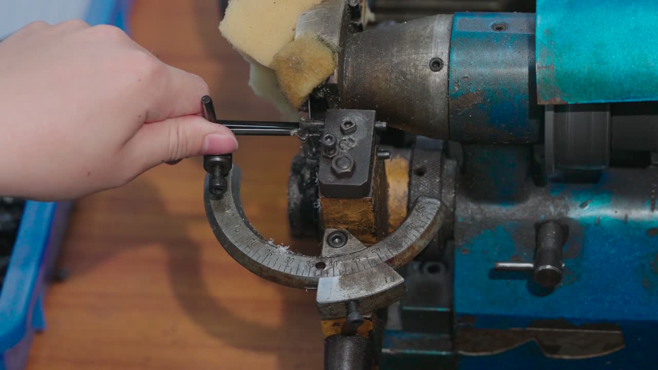 A frame is aligned against an angle gauge on a cutting machine.