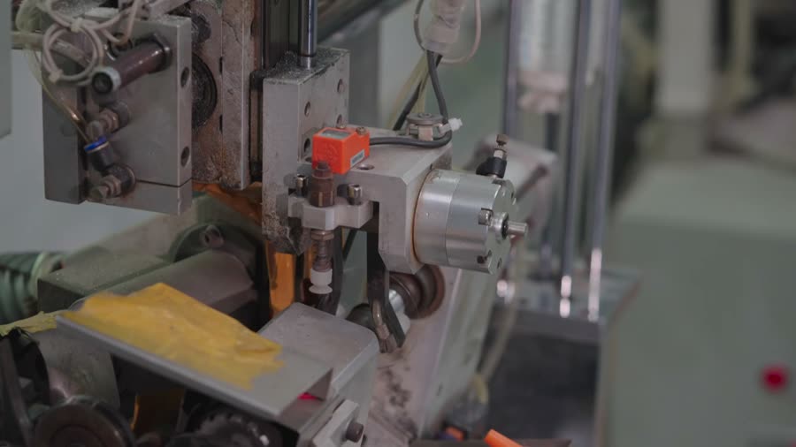 A lens blank is cut to shape on a machine.