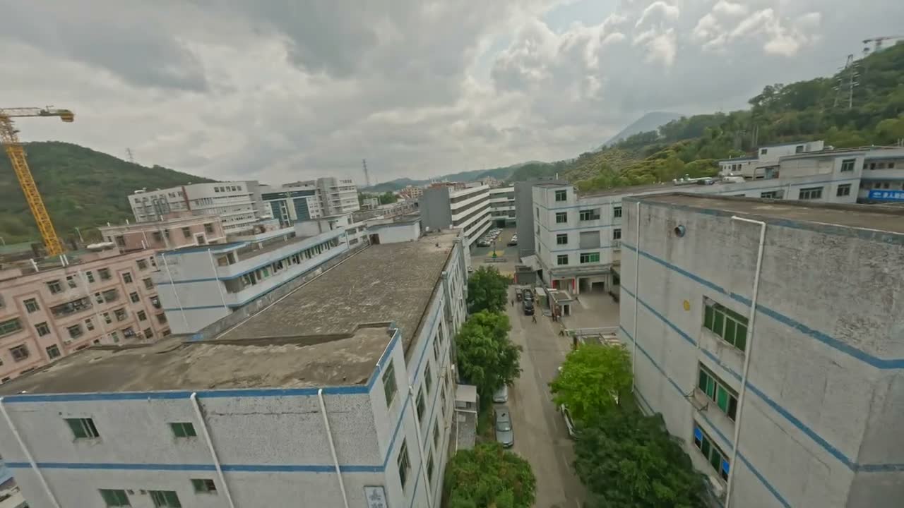 Aerial view over the LIBO factory rooftops at the start of the flythrough.