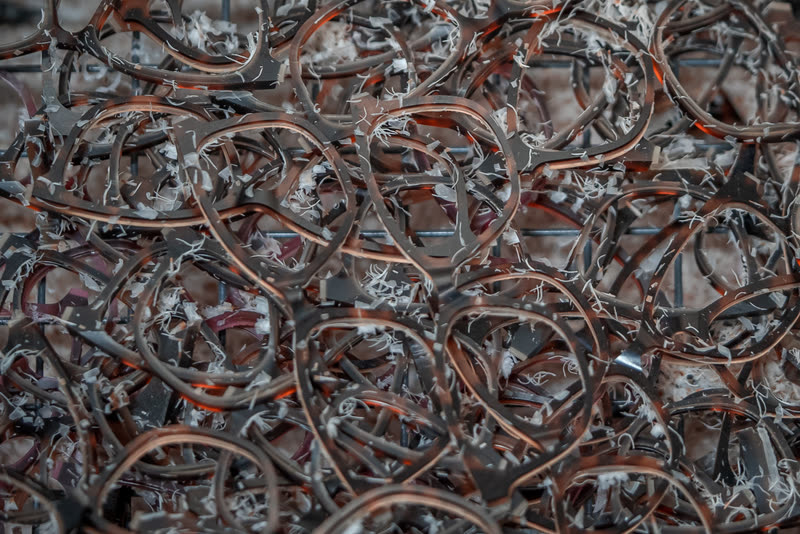 A bin of wire fronts, tangled together after forming.