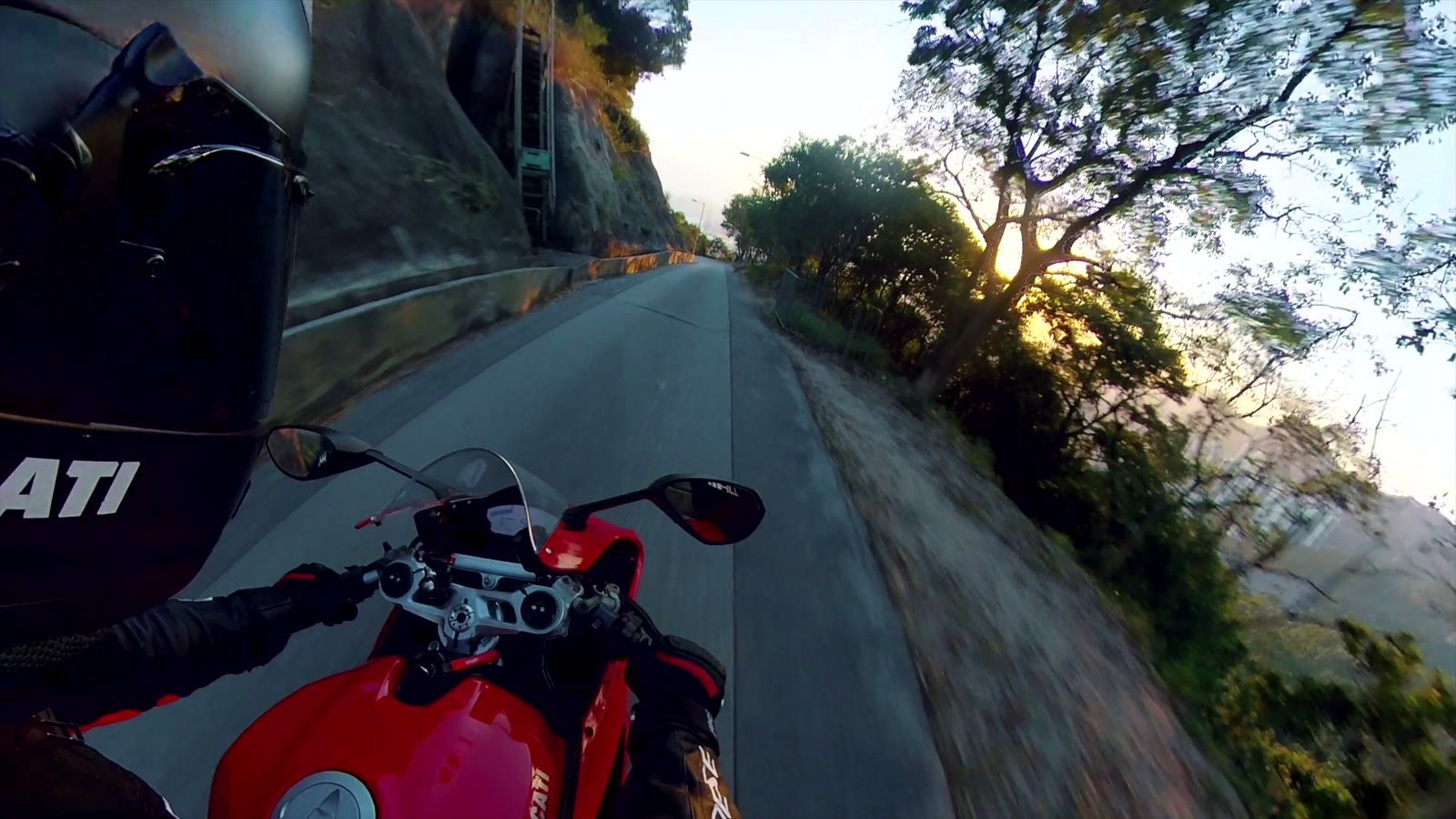 A rider on a red Ducati on a Hong Kong mountain road, filmed from the bike.