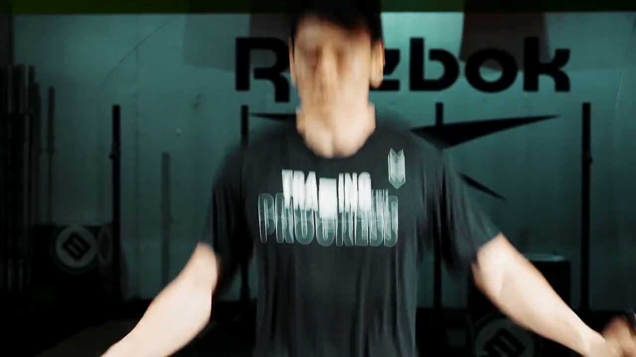 A lifter mid-set in a dark gym.