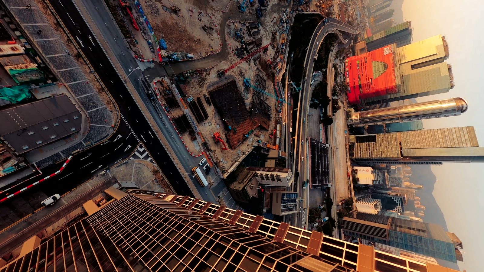 An FPV drone diving down the face of a Hong Kong tower.
