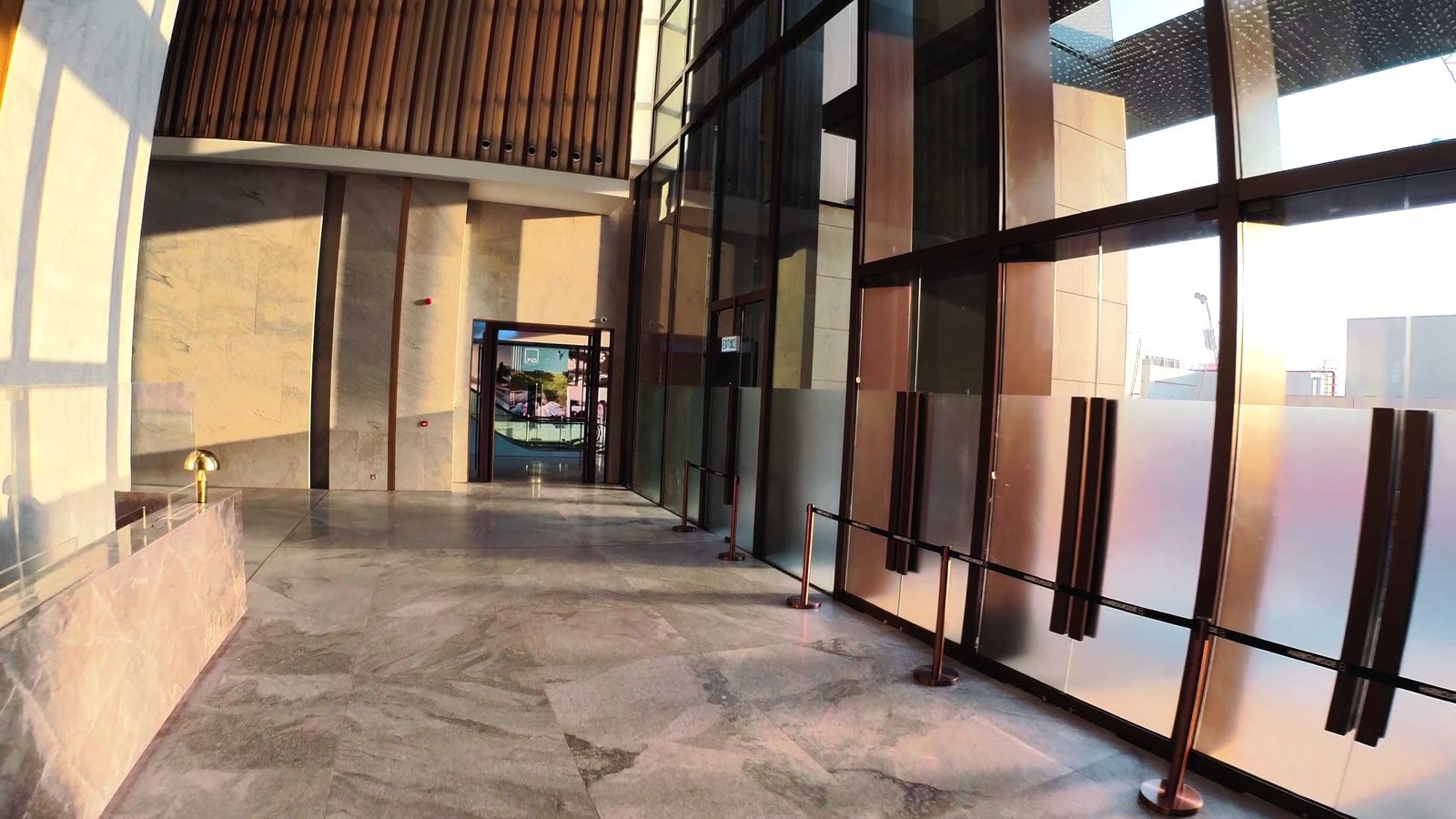 The finished lobby at Harbourside HQ: timber fins, marble and daylight.